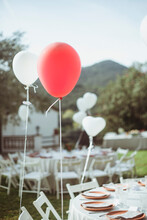 Balloons Tied To Garden Chairs At Summer Garden Party, Spain