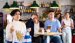 © JackF - Emotional sad young female fan supporting team and holding state flag of Uruguay in hands during rest in sports bar