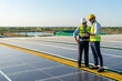 © CandyRetriever  - Professional man engineer using digital tablet maintaining solar cell panels together on building rooftop. Technician team working on ecological solar farm. Renewable clean energy industry concept.