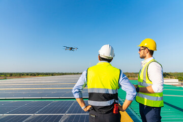 Wall Mural - professional engineer using drone and digital tablet maintaining solar cell panels together on build