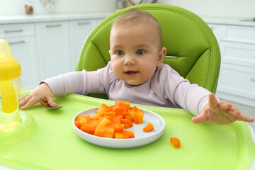 Sticker - Cute little baby eating carrot at home, focus on plate