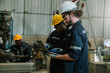 © kelvn - Team of technician worker checking and repair pressing metal machine at factory, Machine maintenance technician operation concept.