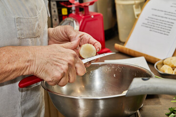 Wall Mural - Chef cuts ginger into bowl for cooking