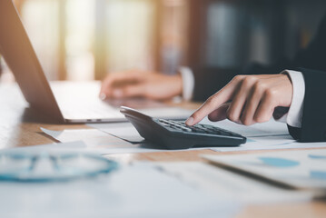Aufkleber - Business people use calculator to calculate documents, profit and loss statement review concept of company performance, effective tax deduction planning for individuals and companies paying tax rates