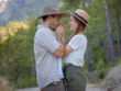 © Seleznov_Molchanova - concept of embracing fresh air and engaging in outdoor activities. Loving young couple hugging and smiling together on nature background. Mountains Forest walk in Turkey