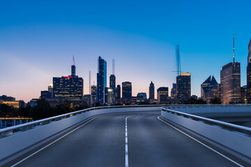 Empty urban asphalt road exterior with city buildings background. New modern highway concrete construction. Concept of way to success. Transportation logistic industry fast delivery. Chicago. USA.