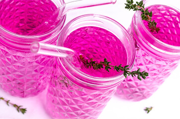 Wall Mural - Pink drink with thyme in a glass