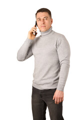 Wall Mural - Young man wearing gray turtleneck sweater and jeans