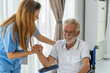 © SKW - Man being cared for by a private Asian nurse at home suffering from Alzheimer's disease to closely care for elderly patients with copy space on left