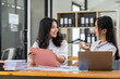 © crizzystudio - Asian female sales representatives in the section of Real estate talked and discussed tax plans to search for information Ask questions and give advice. All information is recorded and detailed.