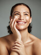 © K.A./peopleimages.com - Skincare, beauty and dermatology woman with cream for acne, health and glow on a studio background. Spa, sunscreen and model thinking of a cosmetics product for anti aging and facial wellness