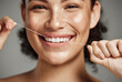 Woman portrait, dental floss and flossing teeth with smile for oral hygiene, health and wellness on studio background. Face of female happy about self care, healthcare and grooming for healthy mouth