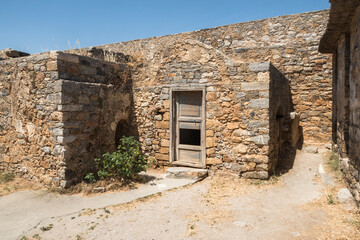 Wall Mural - Dilapidated houses oand ruins on Spinalonga island in Crete, Greece