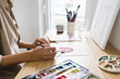 © Cavan - Woman Painting with Watercolor Paint at Home