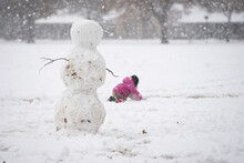 Girl In Pink Rainbow Snowsuit Building Snowman 3