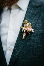 Boutonniere With Fresh And Dried Flowers On Grooms Suit