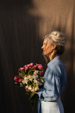 Senior Woman With Bouquet Of Flowers