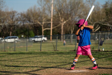 Girl Playing Baseball Wearing Colorful Uniform