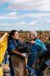© Ezequiel Giménez/Stocksy - Happy lady with grandfather smiling after grape harvest
