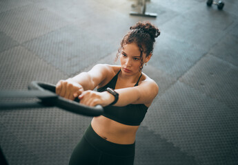 Exercise, gymnast ring and woman doing fitness workout , strength training and body wellness routine. Strong sports female or athlete with dip rings for power, self care and a healthy lifestyle