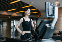Woman Running On The Treadmill.
