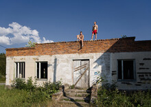 Men On Roof Of Abandoned Building