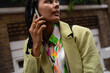 © Tessy Morelli/Stocksy - BIPOC candid woman on phone call