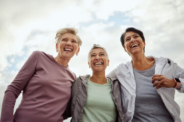 Canvas Print - Diversity, happy women and laughing for sports, fitness and support on mockup sky background. Low angle, senior female group and exercise friends excited for community wellness, freedom or motivation