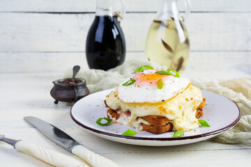 Wall Mural - Delicious breakfast. Hot french toast with ham and bechamel sauce - croque madame