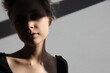 © Lilith Matevosyan/Stocksy - a portrait of a woman in shadow