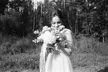 A Bride Smiling With A Flower Bouquet 
