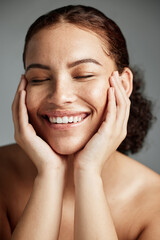 Face, skincare and makeup with a model black woman in studio on a gray background to promote natural care. Facial, wellness and makeup with an attractive young female happy with her cosmetic product