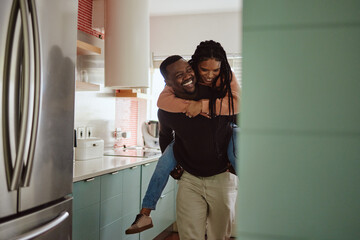 Canvas Print - Black couple, piggyback and love while together in home kitchen with care and happiness in a marriage. Happy young man and laughing woman playing fun game while to bond in their house or apartment