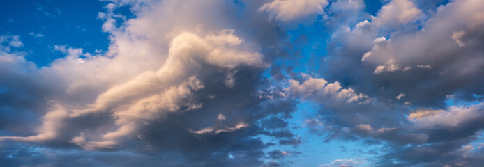 Wall Mural - Panoramic background of evening sky with dramatic stormy clouds