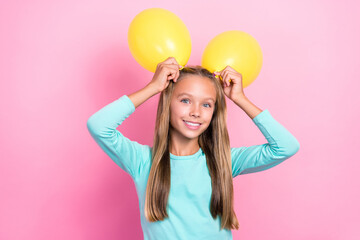 Poster - Closeup photo of young little pretty cute small schoolkid girl toothy smile hold yellow air balloon bunny positive enjoy event isolated on pink color background