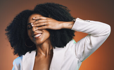 Black woman, hand with manicure and face with beauty, hair care and happy with afro against studio background. Makeup cosmetic, nails and skincare with facial and natural curly hair texture