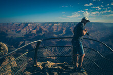 Man Photographing The Sunrise In The Grand Canyon