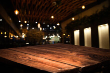 Empty Wooden Brown Table On Blurred Light Gold Bokeh Cafe Restaurant Bar, Place For Your Products On The Table. Abstract Background