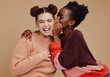 © Siphosethu/peopleimages.com - Friends, gossip and women laughing at secret joke on studio background with smile on face. Secrets, rumor and whisper in ear, black woman with happy woman discuss funny announcement for advertisement