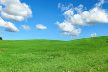 Green Grass Field And Blue Sky With Clouds, Aesthetic Nature Background. Idyllic Grassland, Summer Or Spring Landscape, Green Countryside Fields, Blue Sky Cloudy, Bright Environmental Nature