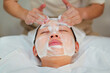 © ADDICTIVE STOCK - Crop beautician doing facial cleansing procedure