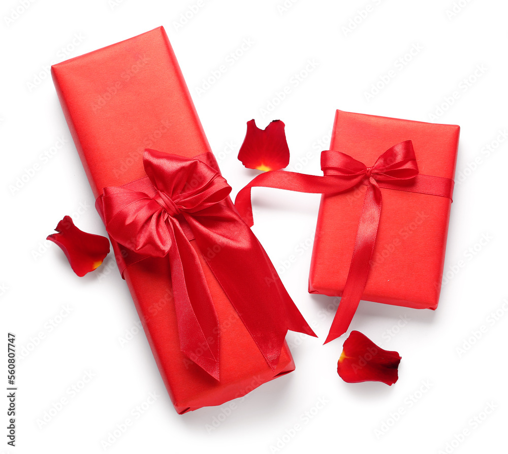 Gifts and rose petals on white background. Valentine's Day celebration