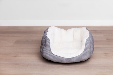 Grey and white empty textile basket bed for dog or cat