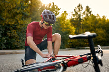 Guy Having Stop, Being Outdoors, Fixing Bicycle By Own Forces, Changing Details, Problems With Movement, Athlete Caucasian Sportsman Wearing Sportive Clothes Having Problems. Bike Repair.