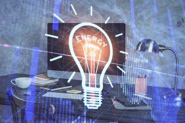 Poster - Computer on desktop in office with bulb icon hologram. Multi exposure. Concept of idea.