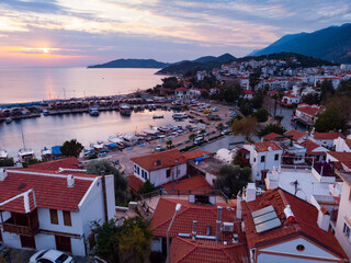 Wall Mural - Picturesque aerial view of coastal area and marina in Kas township in Antalya Province of Turkey during sundown
