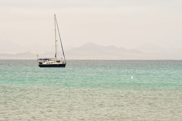 Sailboat with the volcanoes of Caleta de Famara in the background
