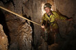 © Cavan Images - A young girl holds a rope in a cave