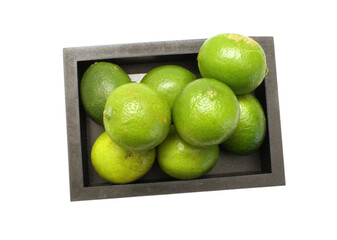 Wall Mural - Fresh ripe lime isolated in wooden crate on white background 