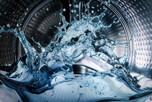Washing Machine Drum With Clean Water Flow And Splashes. Laundry, Washing Powder Concept.
